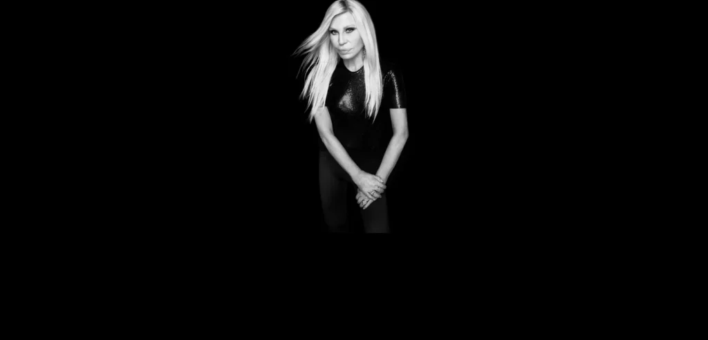 Donatella Versace in the official imagery released with her 2026 joint-venture announcement with REVOLVE.