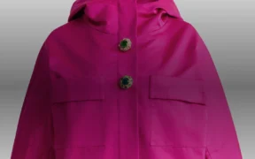 Fuchsia Duchesse satin hooded jacket from Humberto Leon’s Fall 2026 St. John collection, shown front-facing against a light background.